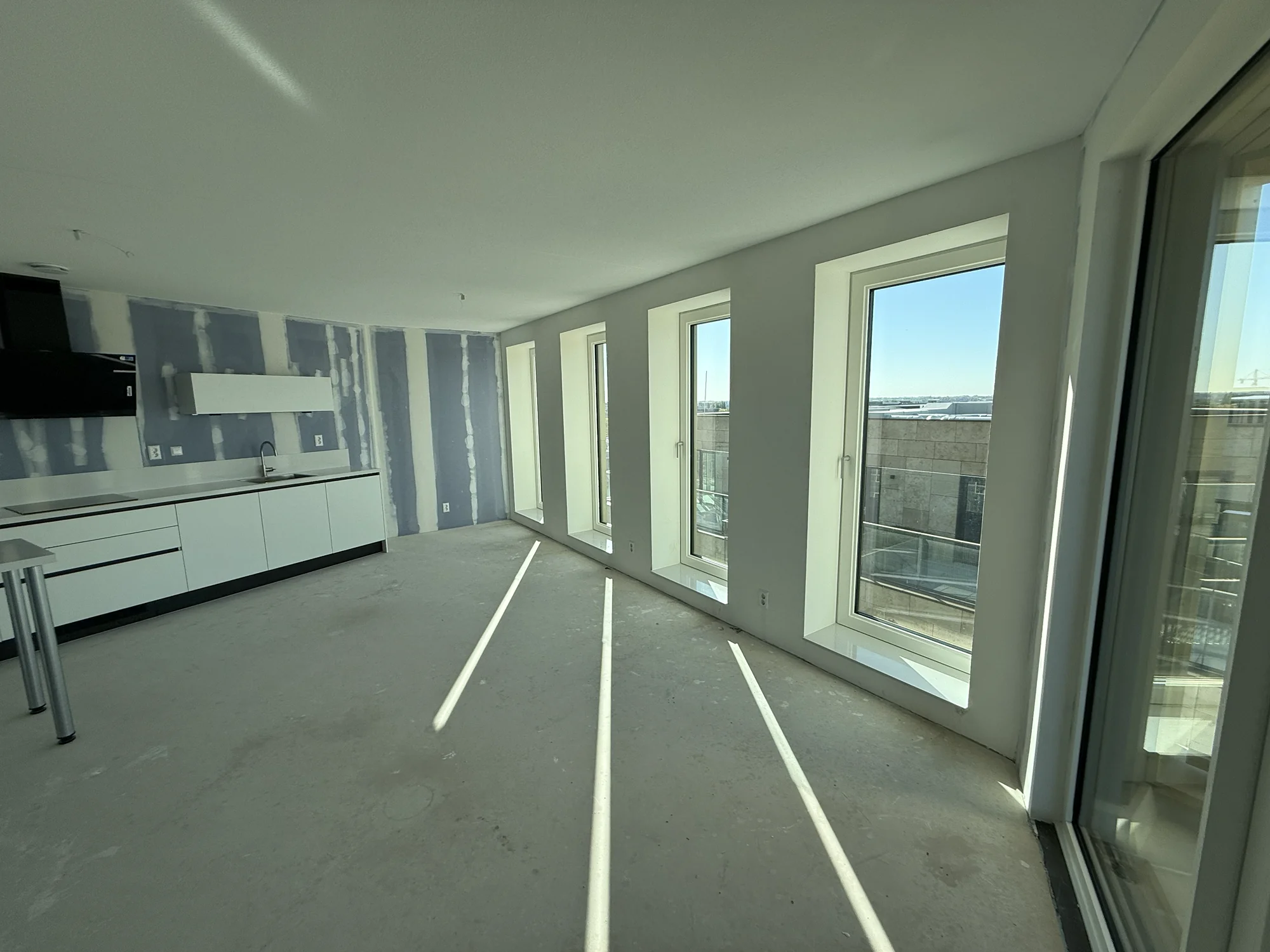 Panoramic windows flooding living room with sunlight